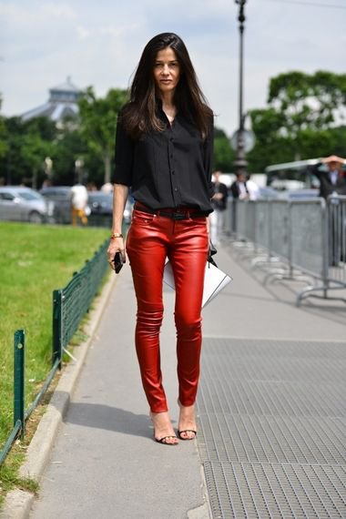 black shirt with buttons and red, narrow leather pants