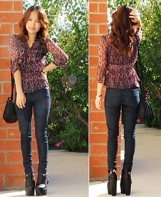 black, semi-transparent chiffon blouse with dark drainpipe jeans and leather ankle boots with high heels