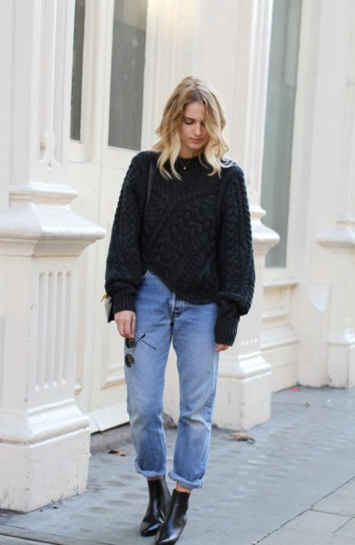 black, chunky sweater with tied mom jeans