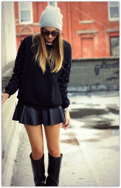 black, chunky sweater with minirater skirt and knee-high boots