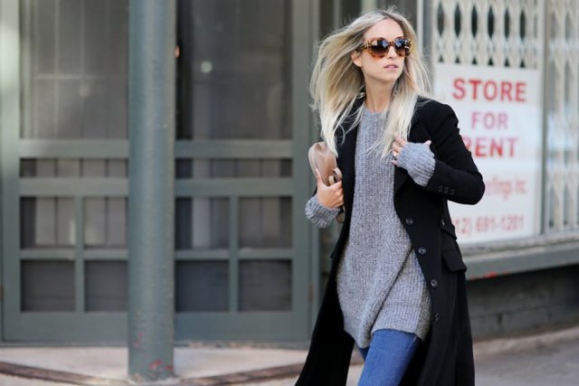black coat with a gray, ribbed sweater dress and blue skinny jeans
