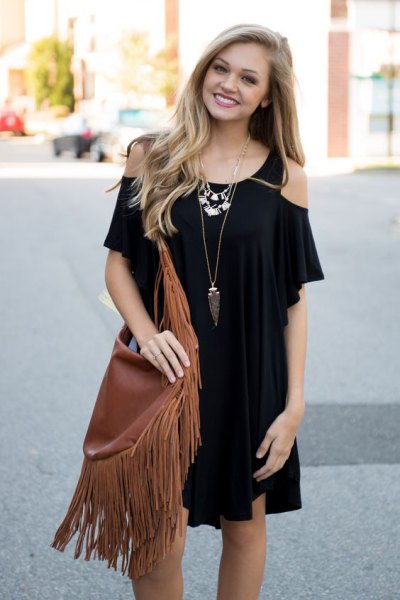 black mini dress with cold shoulder and brown fringed pocket