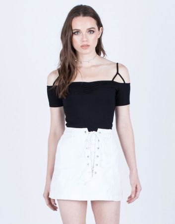 black cold shoulder top with white denim skirt with laces