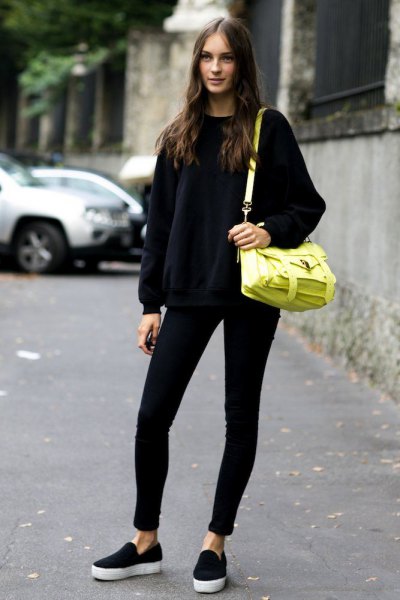 black knitted sweater with round neckline and lemon yellow leather shoulder bag