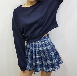 black cropped sweater with boat neckline and checked blue mini skirt