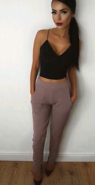 black, short vest top with deep V-neck and gray, high-waisted suit trousers