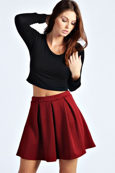 black cut, figure-hugging long-sleeved T-shirt with red mini skirt