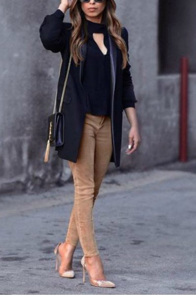 black blouse in front with light brown skinny jeans