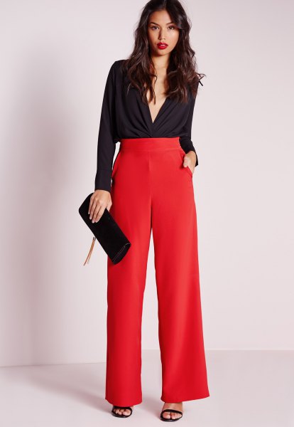 black blouse with deep V-neck and red pants with high waist and wide legs