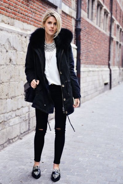 black parka jacket with faux fur collar, white top with tribal print