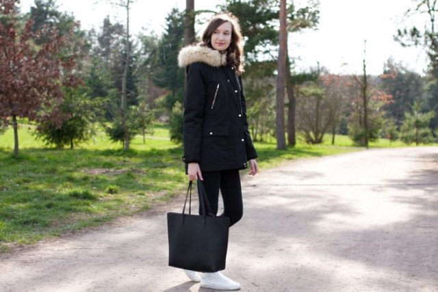 black long coat with hood made of faux fur with matching jeans and sneakers