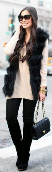 black faux fur vest with white sweater and black skinny jeans