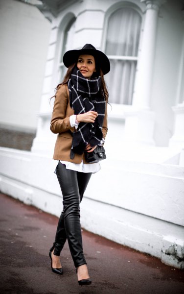 black felt hat and brown blazer and leather gaiters