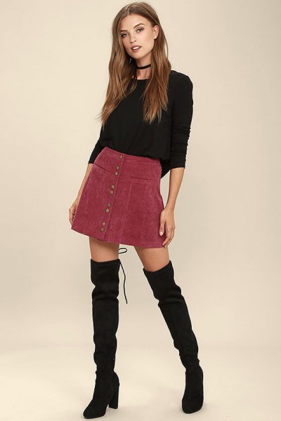 black, fitted sweater with round neckline and burgundy corduroy mini skirt