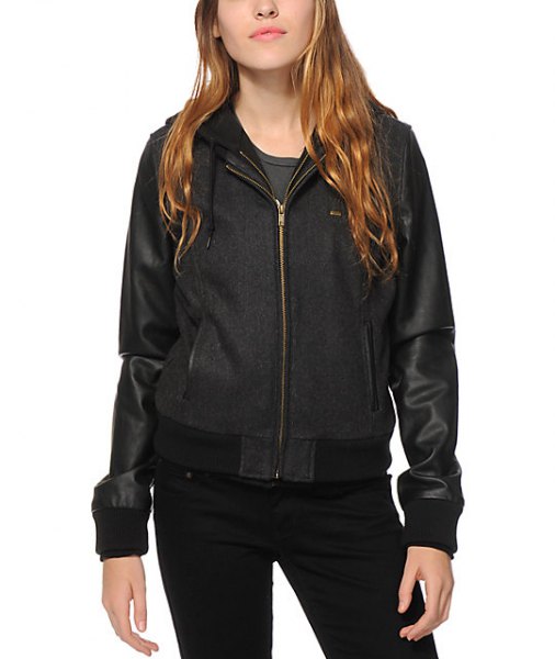 Black tinted bomber jacket with hood made of fleece and leather and skinny jeans