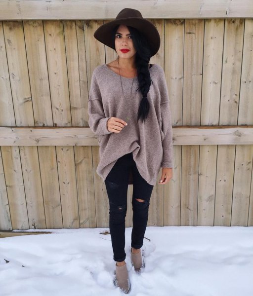 black floppy hat with gray oversized sweater and ripped black jeans