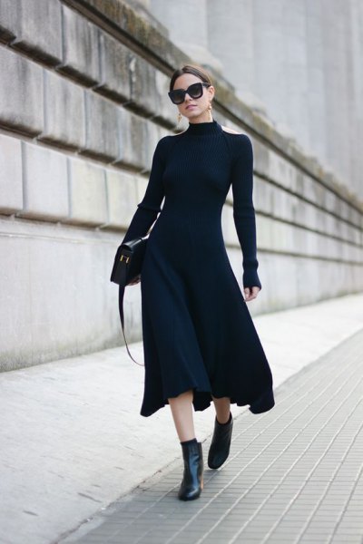 black, figure-hugging midi dress with ankle boots