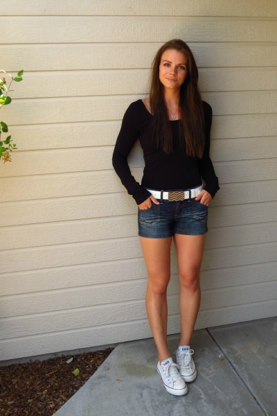 black figure-hugging sweater with denim shorts and white belt