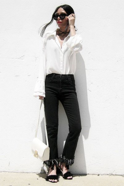 black jeans with fringed hem and white shirt with bell sleeves