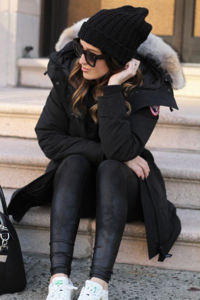 black longline parka jacket with fur collar and leather gaiters