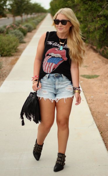 black graphic sleeveless top with light blue high-waisted denim shorts