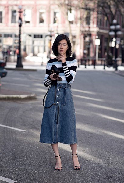 black gray and white striped sweater with blue midi button on the front of the skirt