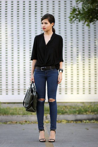 black button-down shirt with half sleeves and ripped dark blue skinny jeans