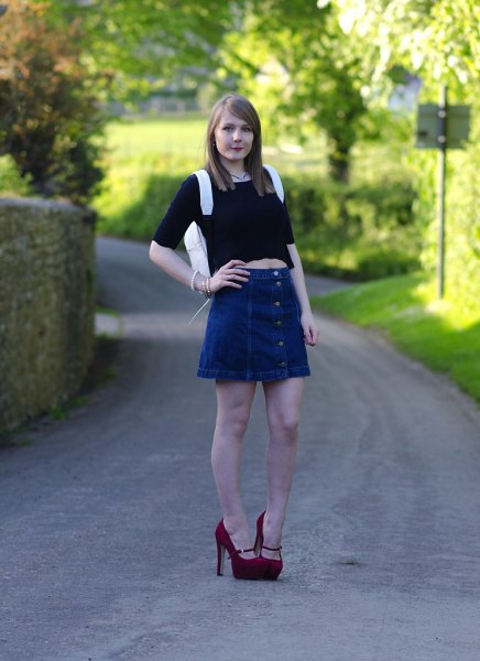 black crop top with half sleeves and a blue, flared denim skirt