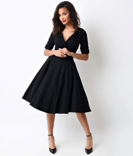 black swing dress with deep V-neck and half sleeves