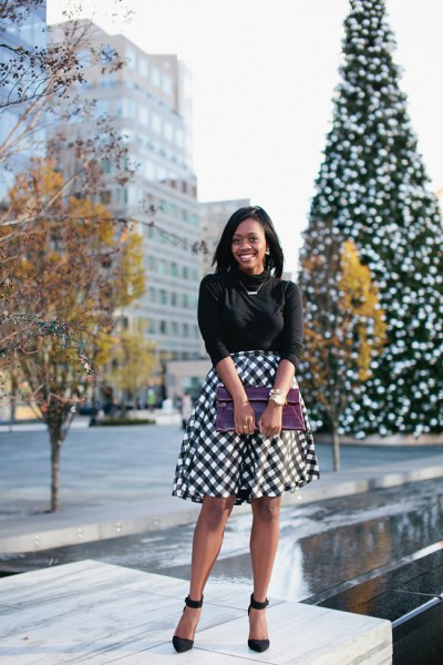 black knitted sweater with half sleeves and checked midi skirt