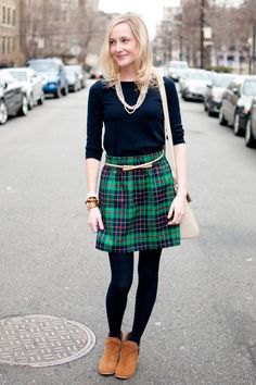 black t-shirt with half sleeves and green and dark blue checked mini skirt