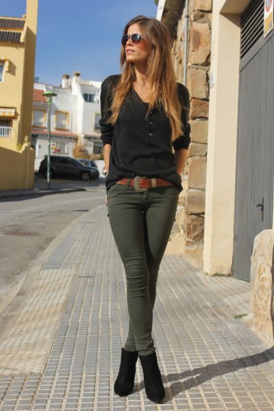 black t-shirt with V-neck and dark olive green drainpipe trousers