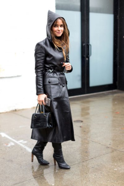 black trench coat made of maxi leather with hood and boots with heel