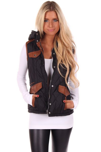 black hooded vest with white, figure-hugging long-sleeved T-shirt and leather gaiters