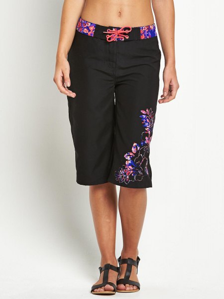 black knee-length board shorts with floral details