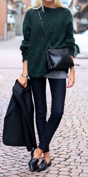 black, coarsely knitted sweater with dark jeans and leather loafers