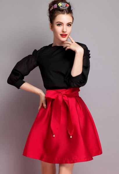 black knitted sweater, red knotted flared skirt
