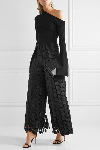 black lace trousers over the top with one shoulder