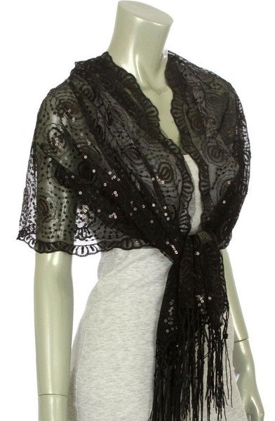 black lace scarf over a light gray, figure-hugging mini dress
