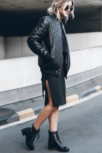 black aviator jacket made of leather with a knee-length dress with a high slit