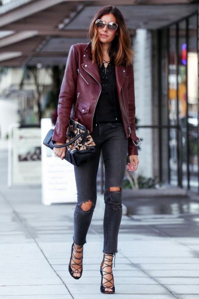 black leather jacket with dark blue, torn, skinny knee jeans