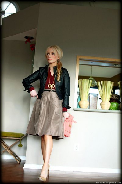 black leather jacket with gray knee-length taffeta skirt