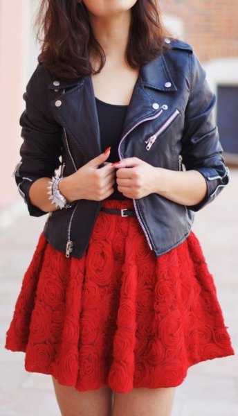 black leather jacket with red, pink skater skirt with belt