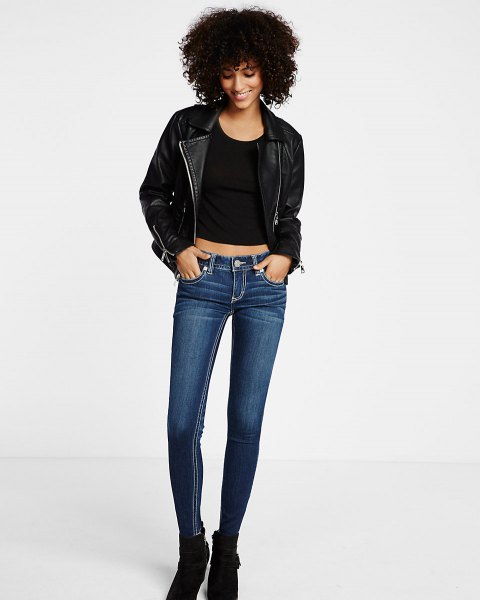 black leather jacket with crop top with scoop neckline and dark blue skinny jeans