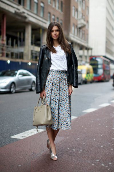 black leather jacket with white blouse and pleated skirt with floral pattern