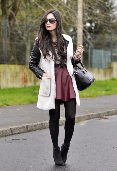 black leather jacket with white fleece vest and maroon silk skater skirt