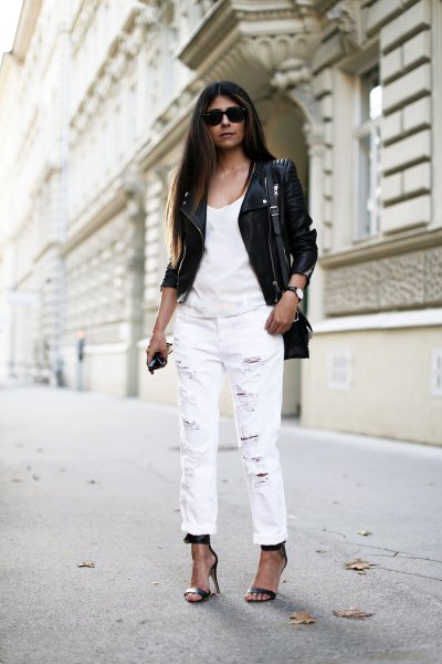black leather moto jacket with white tank top and straight leg jeans with cuff