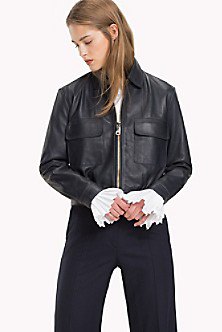 Sporty coat made of black leather with dark straight-leg jeans