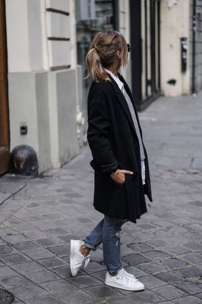black long coat with gray sweater and white shirt with buttons