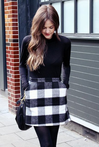 black long-sleeved t-shirt with gray and white checked wool miniskirt with pockets